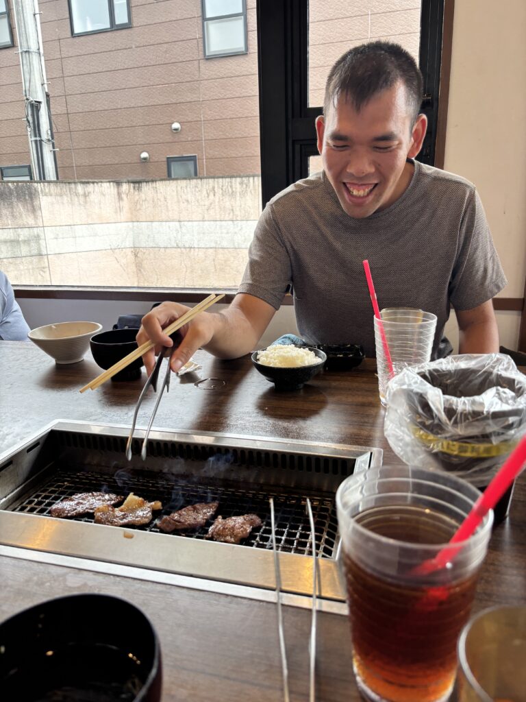 焼き肉を焼く利用者さんの笑顔